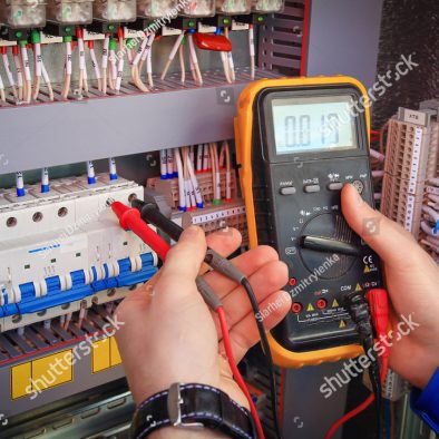 stock-photo-multimeter-is-in-hands-of-electrician-on-background-of-electrical-automation-cabinet-adjustment-of-682415344